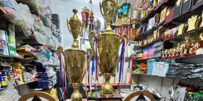Beautifully crafted gold trophies and wooden awards by RR Sports for school annual sports meet.